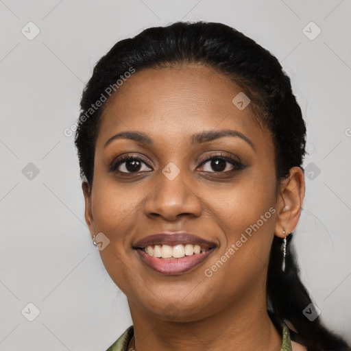 Joyful black young-adult female with long  black hair and brown eyes