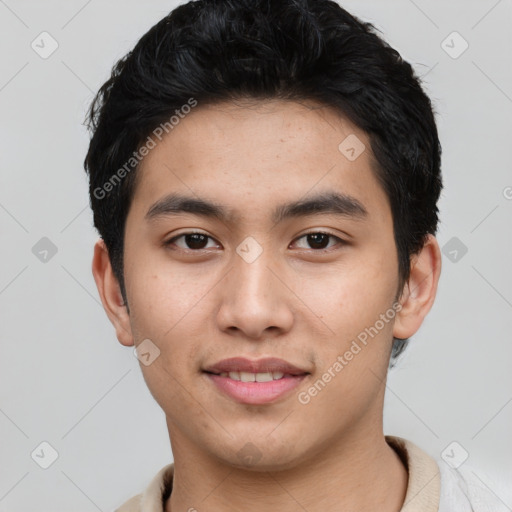 Joyful asian young-adult male with short  black hair and brown eyes