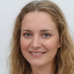 Joyful white young-adult female with long  brown hair and blue eyes