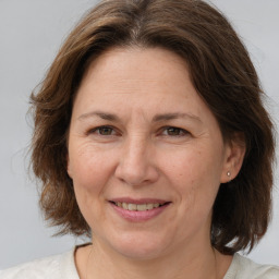 Joyful white adult female with medium  brown hair and brown eyes