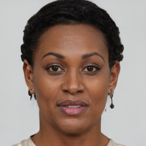 Joyful black young-adult female with short  brown hair and brown eyes