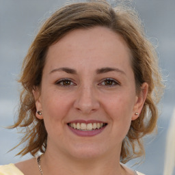 Joyful white young-adult female with medium  brown hair and grey eyes