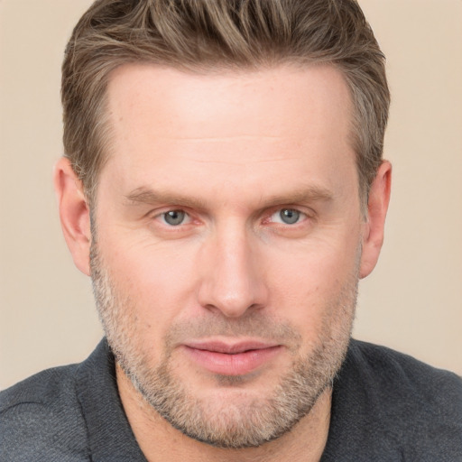 Joyful white adult male with short  brown hair and grey eyes