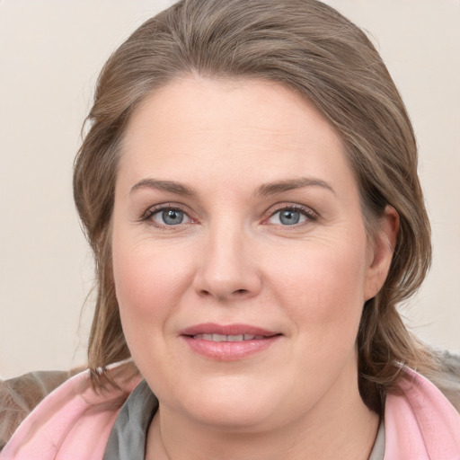 Joyful white young-adult female with medium  brown hair and blue eyes