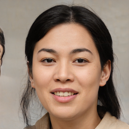 Joyful asian young-adult female with medium  black hair and brown eyes