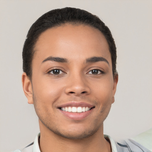 Joyful white young-adult male with short  black hair and brown eyes