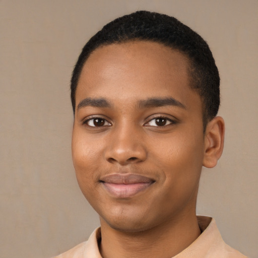 Joyful black young-adult male with short  black hair and brown eyes