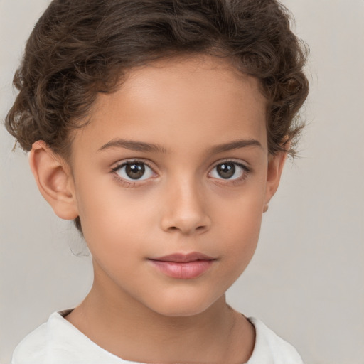 Joyful white child female with short  brown hair and brown eyes