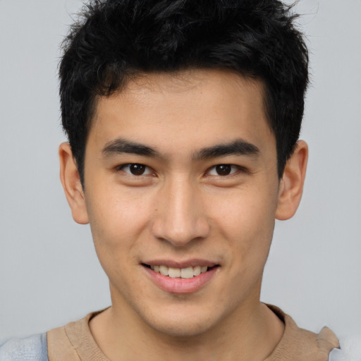 Joyful asian young-adult male with short  brown hair and brown eyes