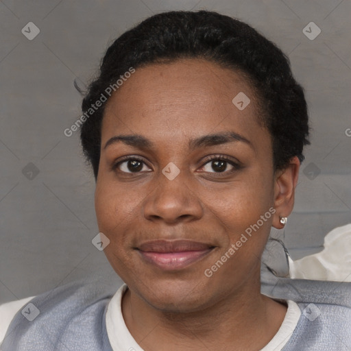 Joyful black adult female with short  black hair and brown eyes