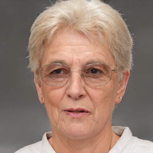 Joyful white middle-aged female with short  gray hair and brown eyes