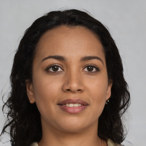 Joyful latino young-adult female with long  black hair and brown eyes