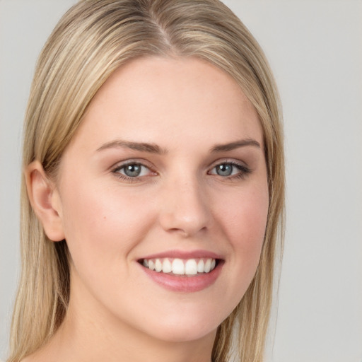 Joyful white young-adult female with long  brown hair and grey eyes