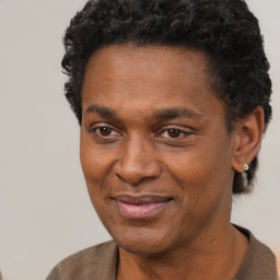 Joyful black adult male with short  black hair and brown eyes