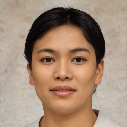 Joyful asian young-adult female with short  black hair and brown eyes