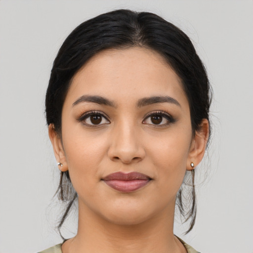Joyful latino young-adult female with medium  black hair and brown eyes