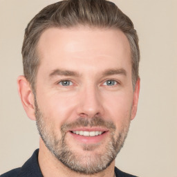 Joyful white adult male with short  brown hair and grey eyes