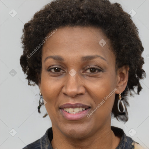 Joyful black adult female with short  brown hair and brown eyes