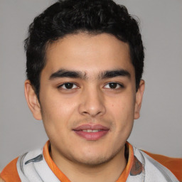 Joyful latino young-adult male with short  brown hair and brown eyes