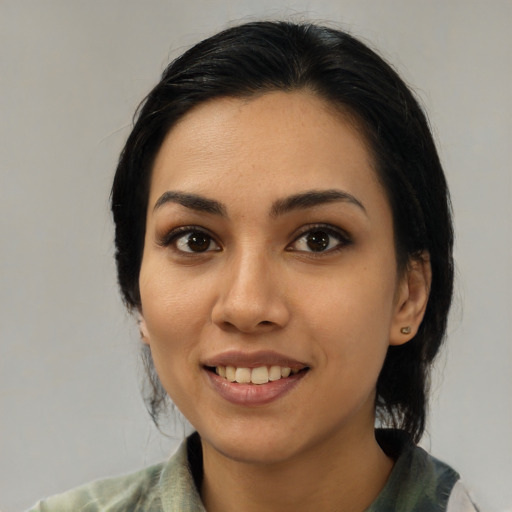 Joyful latino young-adult female with medium  black hair and brown eyes