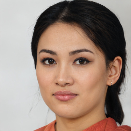 Joyful asian young-adult female with medium  black hair and brown eyes