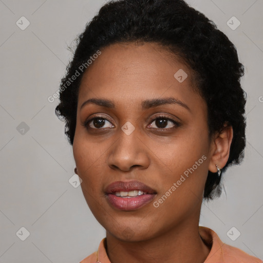 Joyful black young-adult female with short  black hair and brown eyes