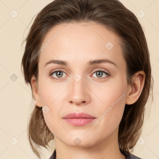 Joyful white young-adult female with medium  brown hair and green eyes