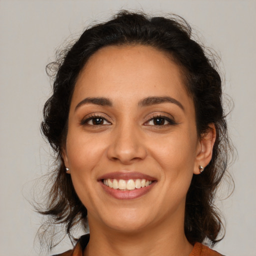 Joyful latino young-adult female with medium  brown hair and brown eyes