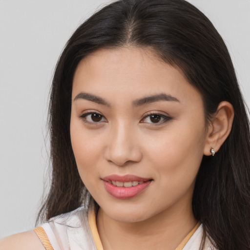 Joyful asian young-adult female with long  brown hair and brown eyes