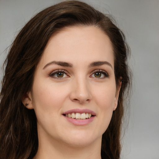 Joyful white young-adult female with long  brown hair and green eyes