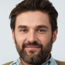 Joyful white adult male with short  brown hair and brown eyes