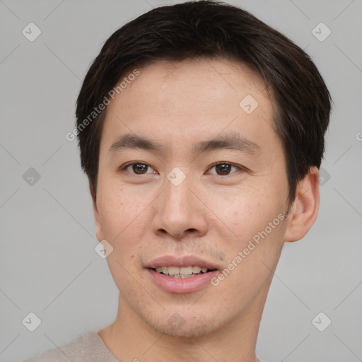 Joyful asian young-adult male with short  brown hair and brown eyes