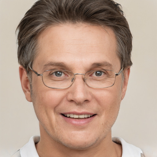 Joyful white adult male with short  brown hair and grey eyes