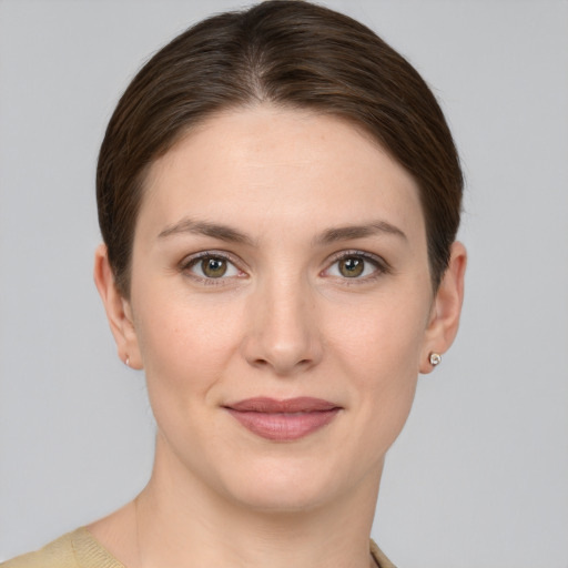 Joyful white young-adult female with short  brown hair and grey eyes