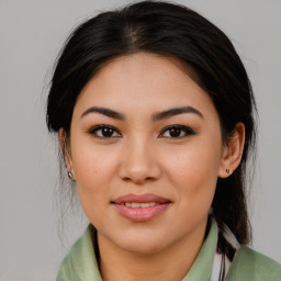 Joyful asian young-adult female with long  brown hair and brown eyes