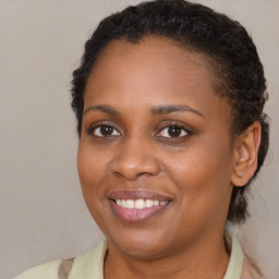 Joyful black young-adult female with medium  brown hair and brown eyes