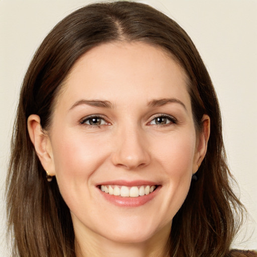 Joyful white young-adult female with long  brown hair and brown eyes