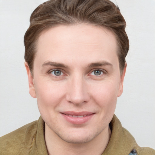 Joyful white young-adult female with short  brown hair and grey eyes