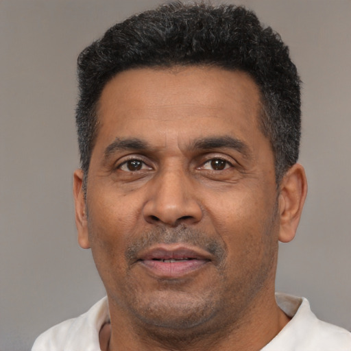 Neutral latino adult male with short  black hair and brown eyes