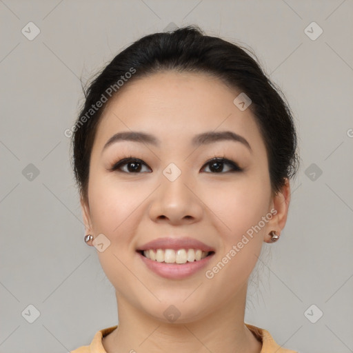 Joyful asian young-adult female with medium  black hair and brown eyes