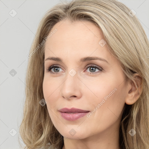 Joyful white young-adult female with long  brown hair and green eyes