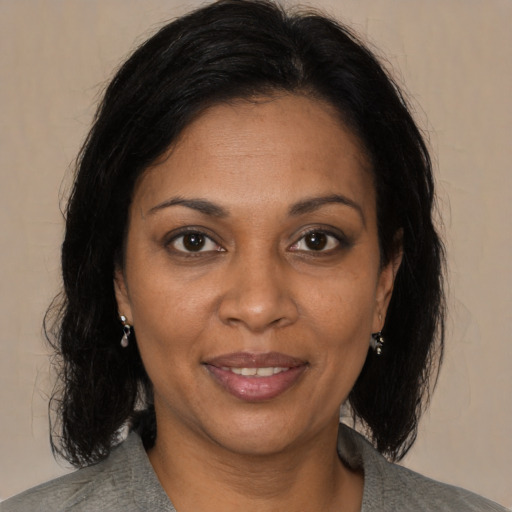 Joyful black adult female with medium  brown hair and brown eyes