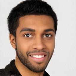 Joyful black young-adult male with short  black hair and brown eyes