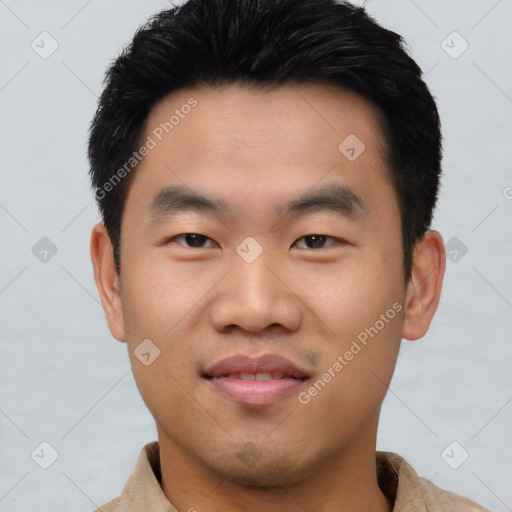 Joyful asian young-adult male with short  black hair and brown eyes