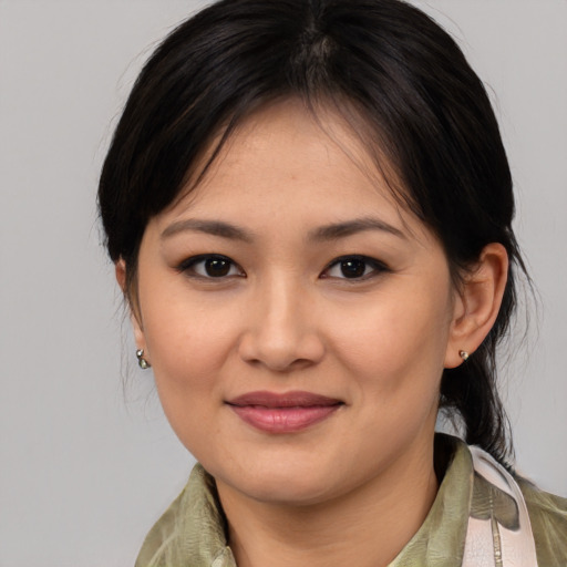 Joyful asian young-adult female with medium  brown hair and brown eyes