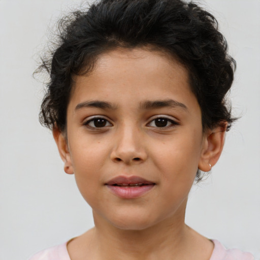 Joyful latino child female with short  brown hair and brown eyes