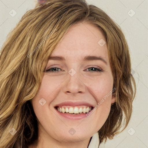 Joyful white young-adult female with long  brown hair and green eyes