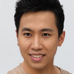 Joyful asian young-adult male with short  brown hair and brown eyes