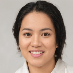 Joyful latino young-adult female with medium  brown hair and brown eyes