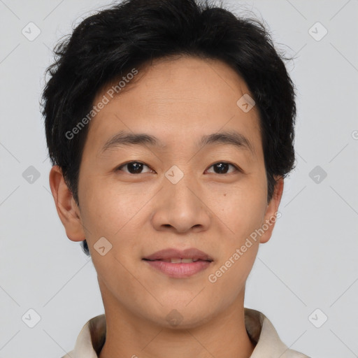 Joyful asian young-adult male with short  brown hair and brown eyes